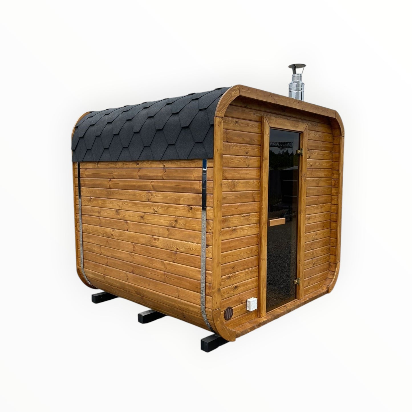 Moderne rechteckige polarsauna shop Gartensauna aus hellem Holz mit schwarzem Bitumendach und Glastür im Außenbereich